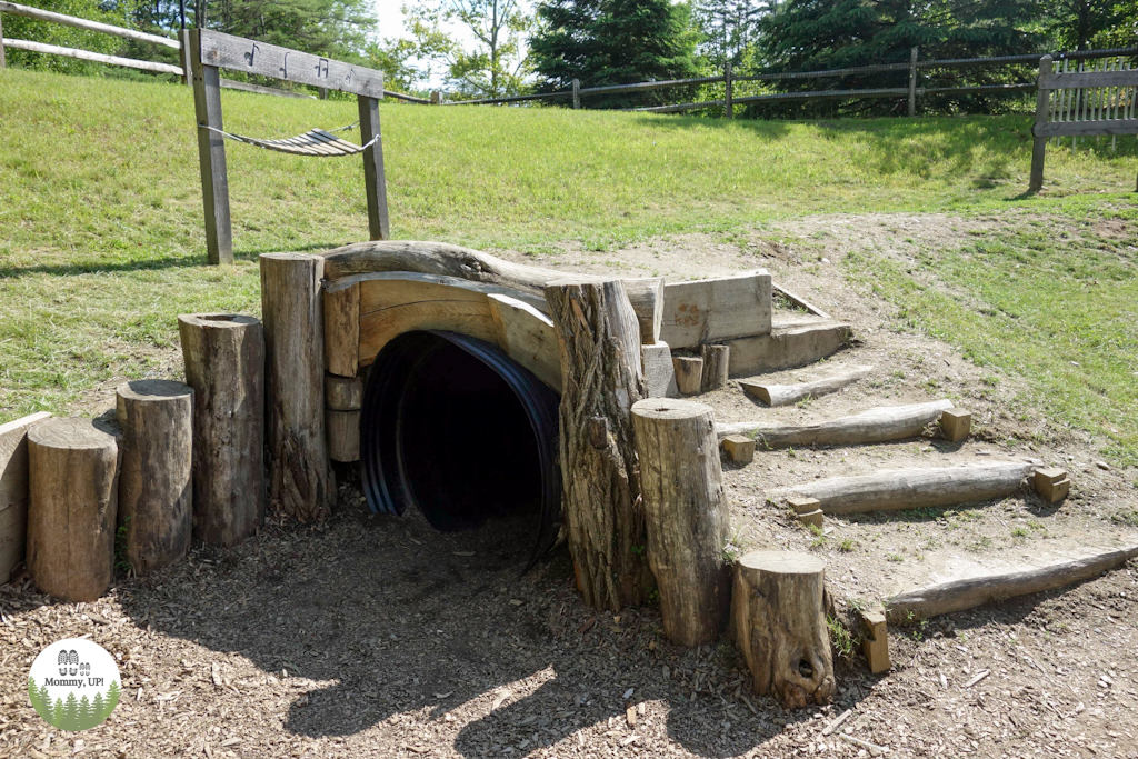 A tunnel in the adventure playscape natural play area at VINS VT